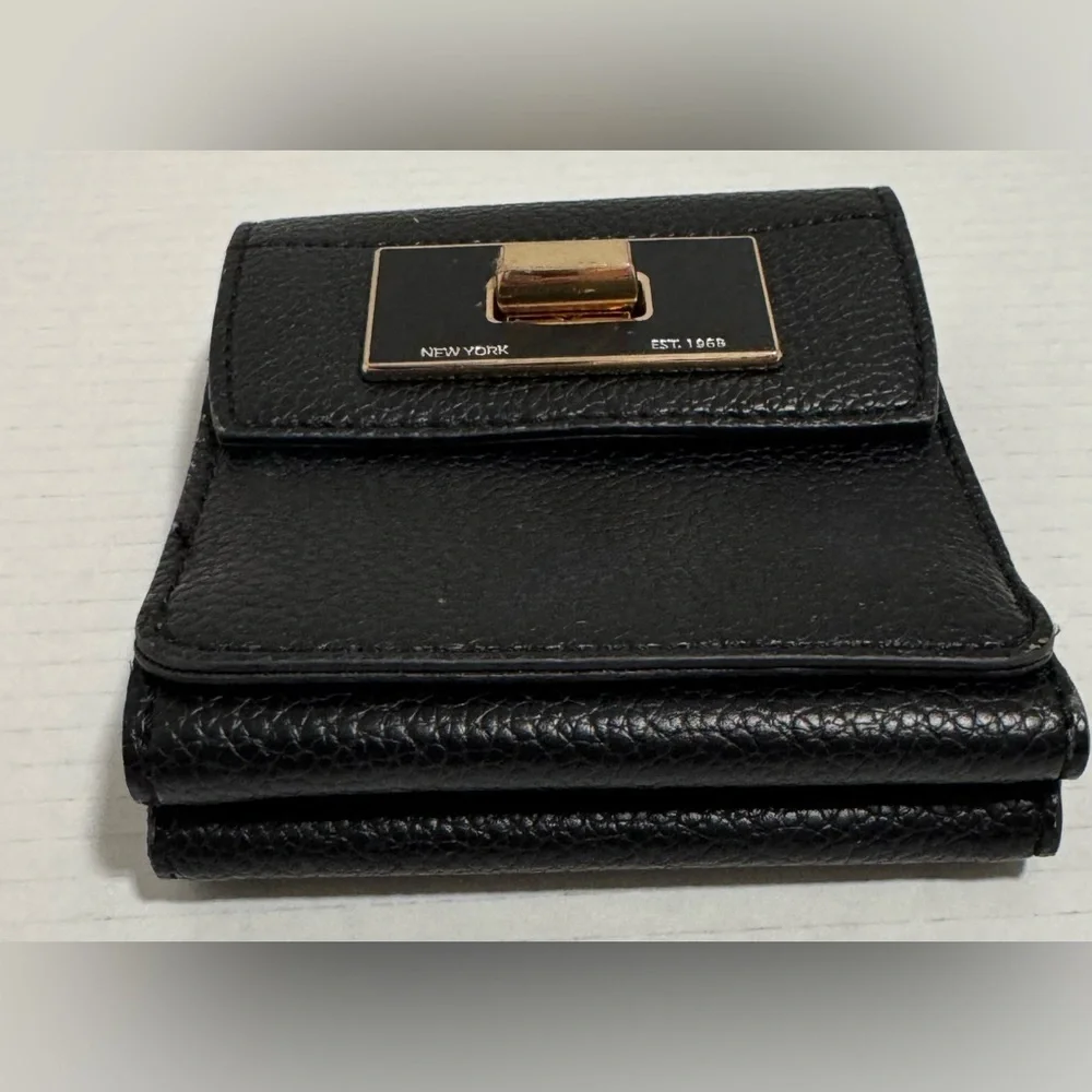 Calvin Klein black trifold wallet with a gold-tone metal closure